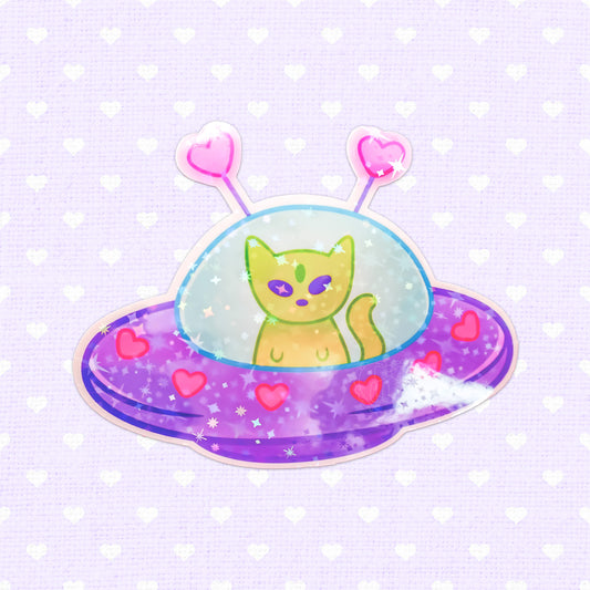 Colorful vinyl sticker featuring a green cat in a purple UFO adorned with hearts and stars, ideal for cat lovers and space enthusiasts.