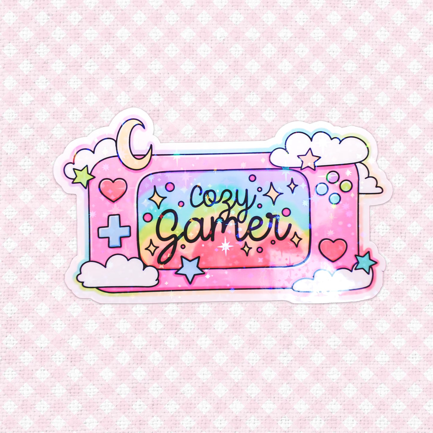 Charming holographic vinyl sticker labeled 'Cozy Gamer' surrounded by colorful stars and clouds, ideal for personalizing your gaming gear.