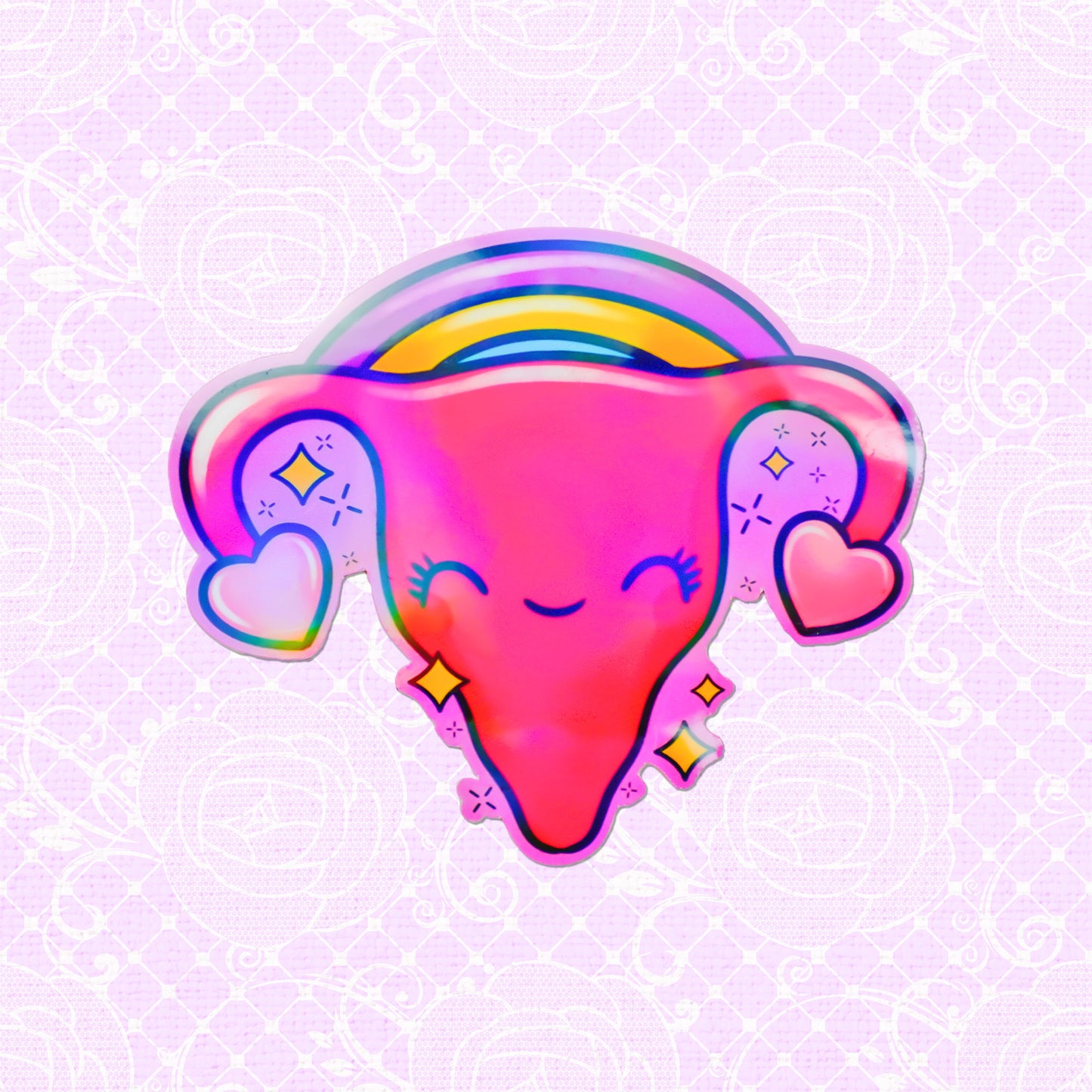 Holographic vinyl sticker of a smiling uterus under a rainbow, ideal for adding a playful and positive touch to any setting