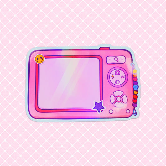 Holographic vinyl sticker of a retro digital camera with a beaded strap and smiley face detail, perfect for fans of 2000s aesthetics.