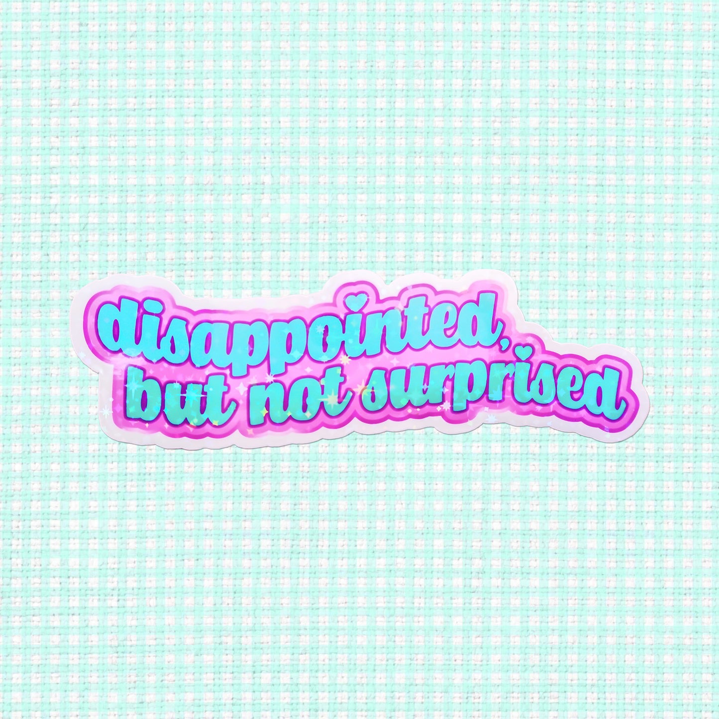 Holographic vinyl sticker with the phrase 'Disappointed, but not surprised' in vibrant pink and purple, ideal for those who want to express their mood stylishly