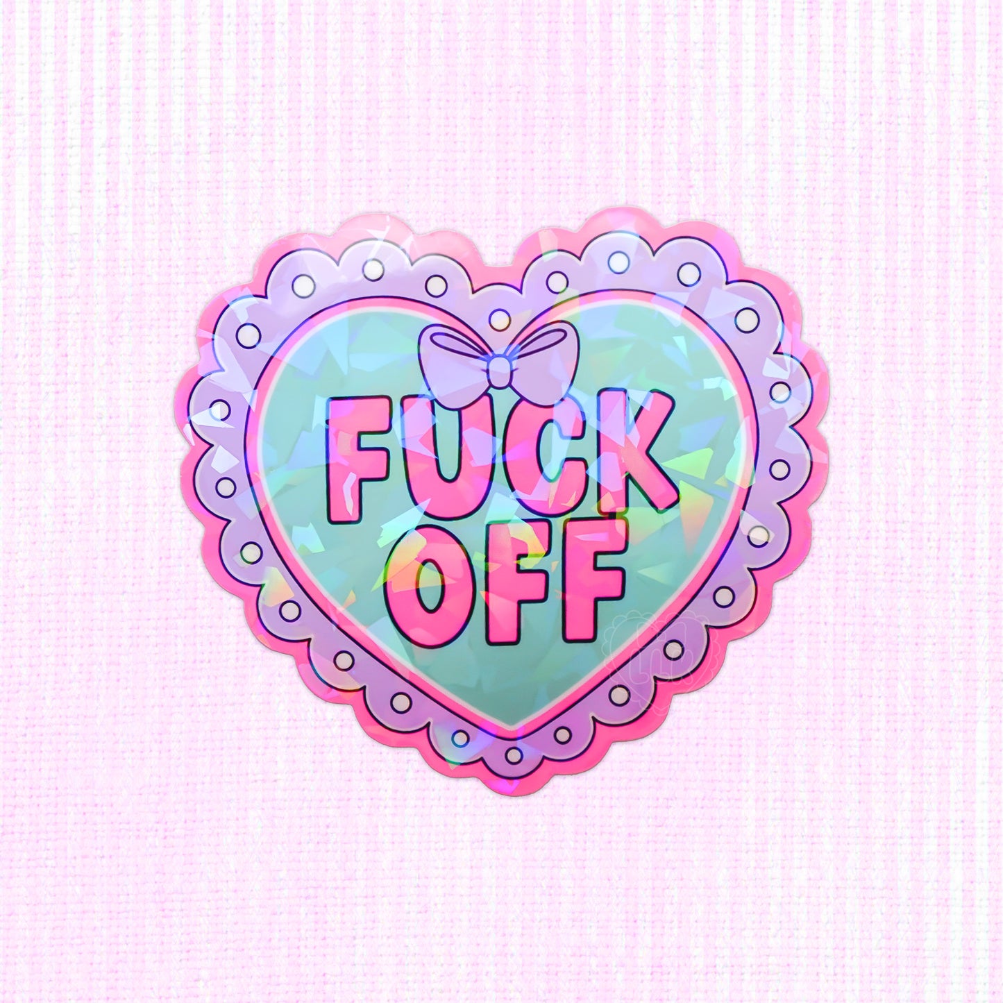 Pastel heart-shaped holographic vinyl sticker with the words fuck off.