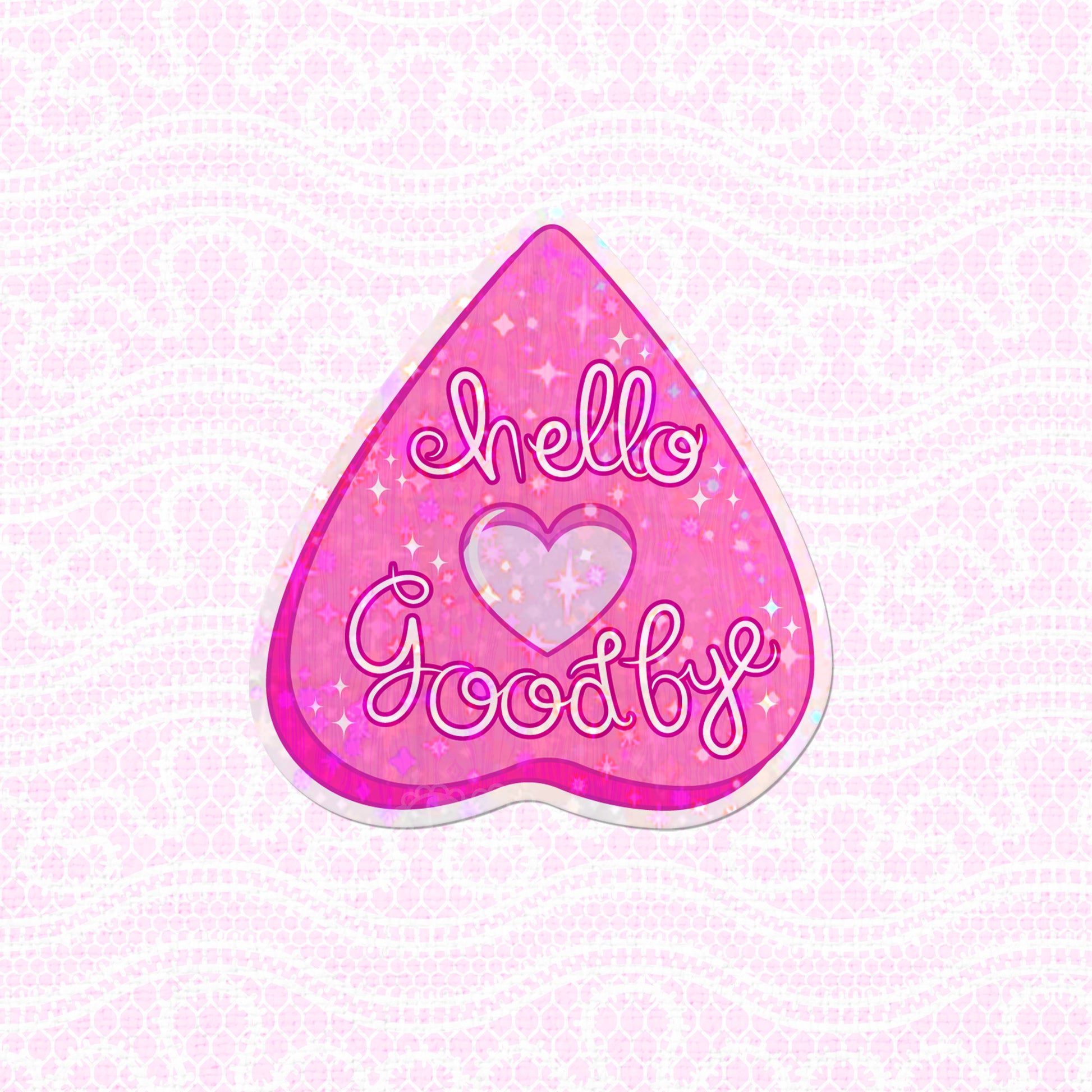 A pastel pink planchette with "Hello Goodbye" text in a sparkly design, available as a vinyl sticker.